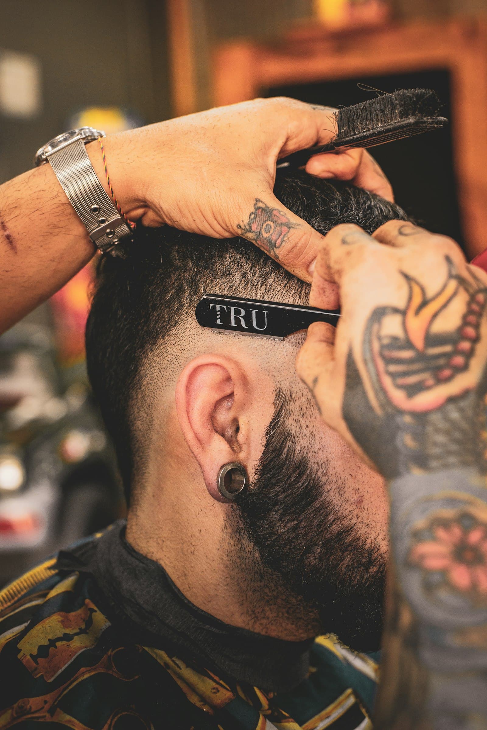A cut in progress, scissor work on textured hair.